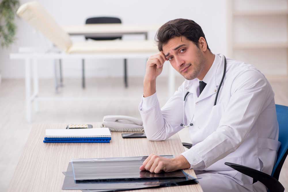 distraught dental provider at desk